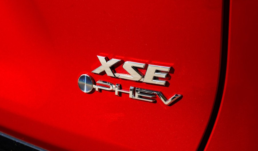 The PHEV badge on a red Toyota RAV4.