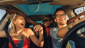 A car-full of friends after the decision of who will ride shotgun.