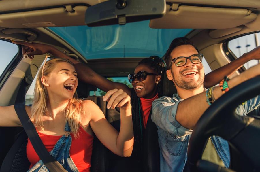 A car-full of friends after the decision of who will ride shotgun.