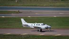 A Beechcraft King Air 90 series landing on a runway