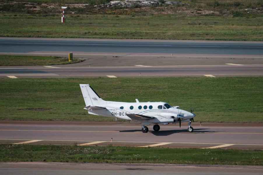 A Beechcraft King Air 90 series landing on a runway