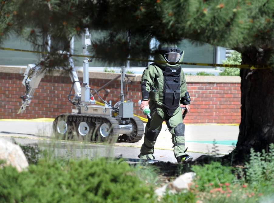 An officer responds to a bomb threat near a car park.