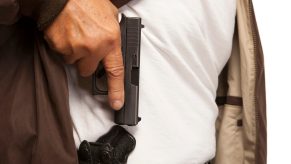 A man with a concealed carry Glock 43 in an IWB holster.