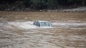 A driver will have to file a claim with their car insurance provider after their vehicle has flood damage.