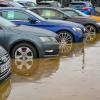 A flooded car lot like the ones in the aftermath of Hurricane Helene shows off its inventory of water-damaged cars.