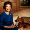 Queen Elizabeth II sitting with a corgi