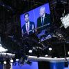 A monitor on the U.S. 2024 Vice Presidential debate stage shows both candidates, Governor Tim Walz and Senator J.D. Vance.