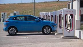 A row of Tesla Supercharger stalls and a Hyundai EV.