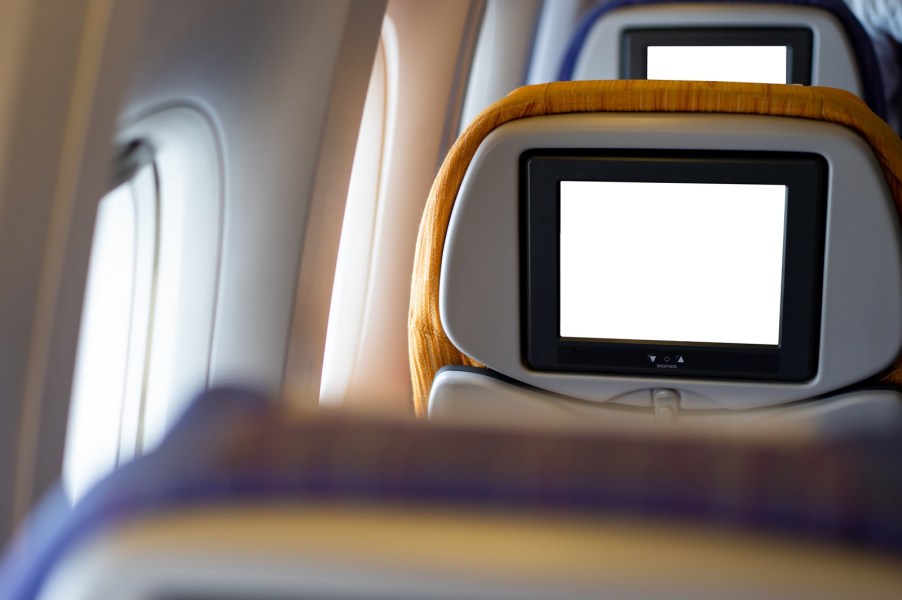 Blank in-flight entertainment screens on an airplane