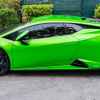 A green Lamborghini Huracán Tecnica parked outside in full left profile view