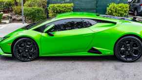 A green Lamborghini Huracán Tecnica parked outside in full left profile view