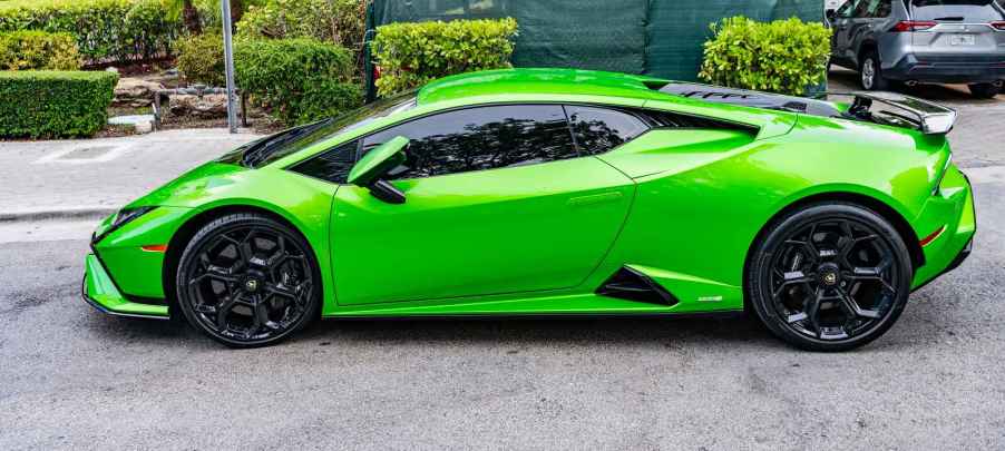 A green Lamborghini Huracán Tecnica parked outside in full left profile view