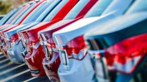 New car lot showing a row of cars photographed in close right rear angle